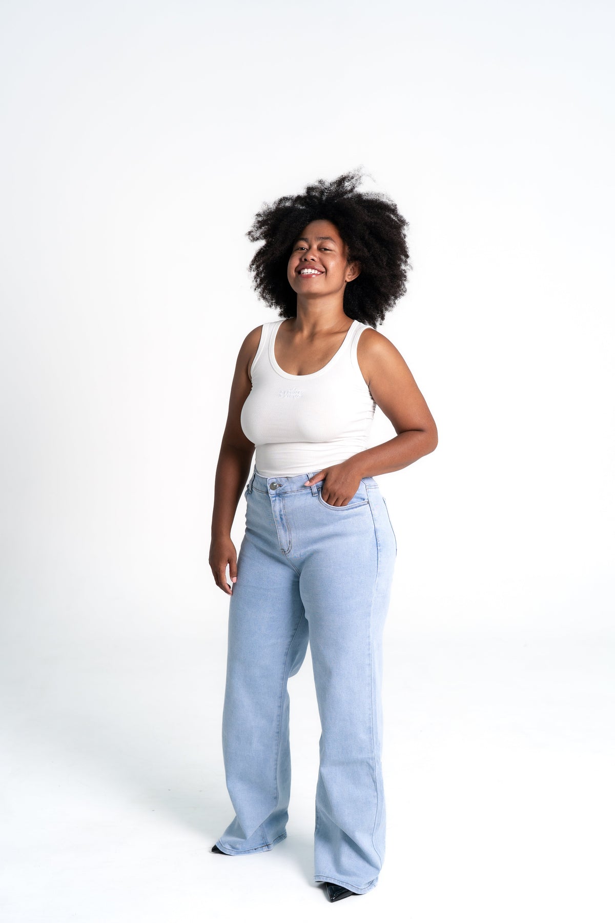 Woman styling stretchy light wash wide leg jeans