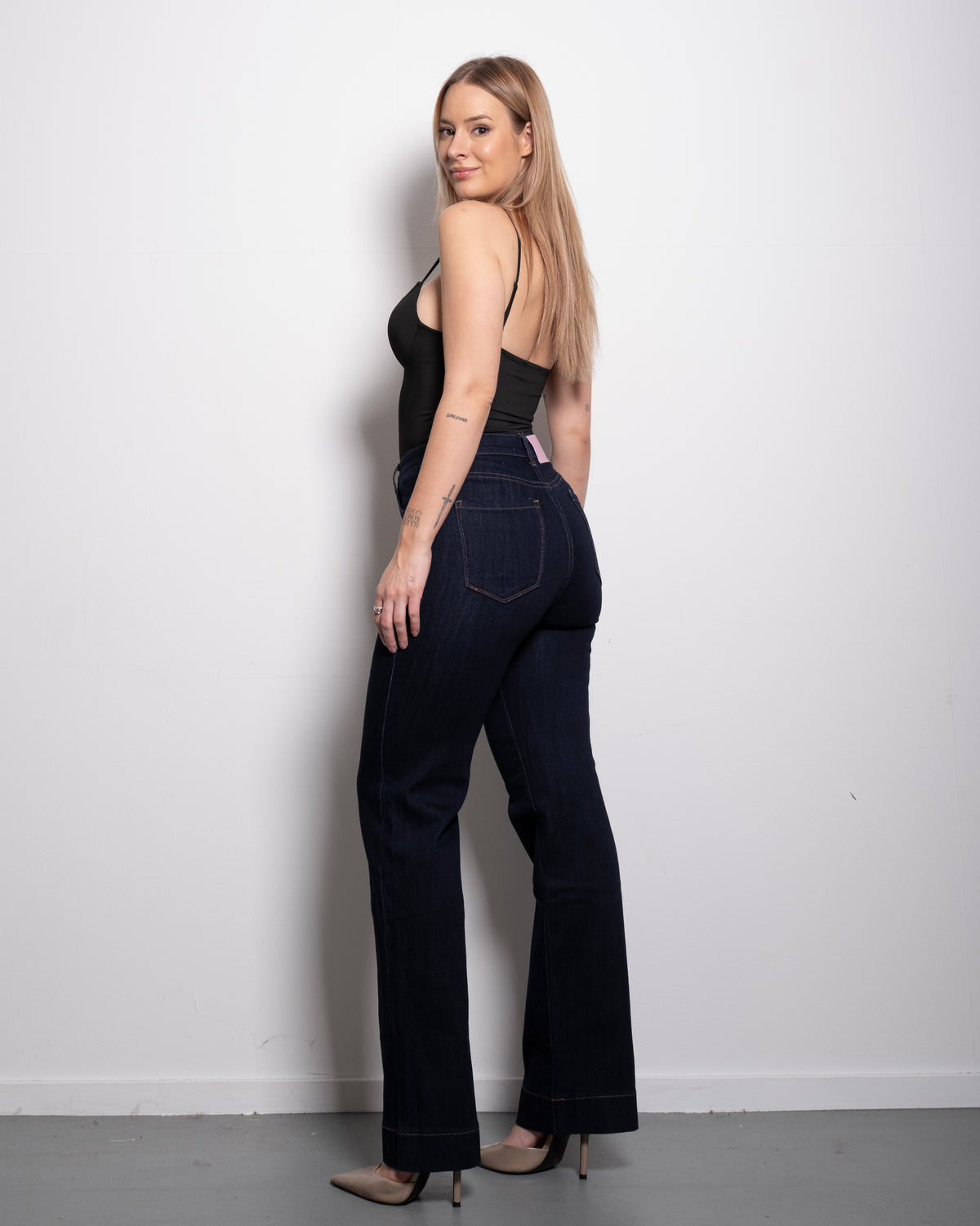 Raw denim stretchy straight leg jeans with contrast stitch and pink patch, curvy fit, worn by model in size 40