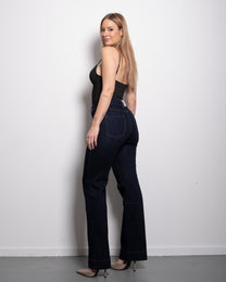 Raw denim stretchy straight leg jeans with contrast stitch and pink patch, curvy fit, worn by model in size 40