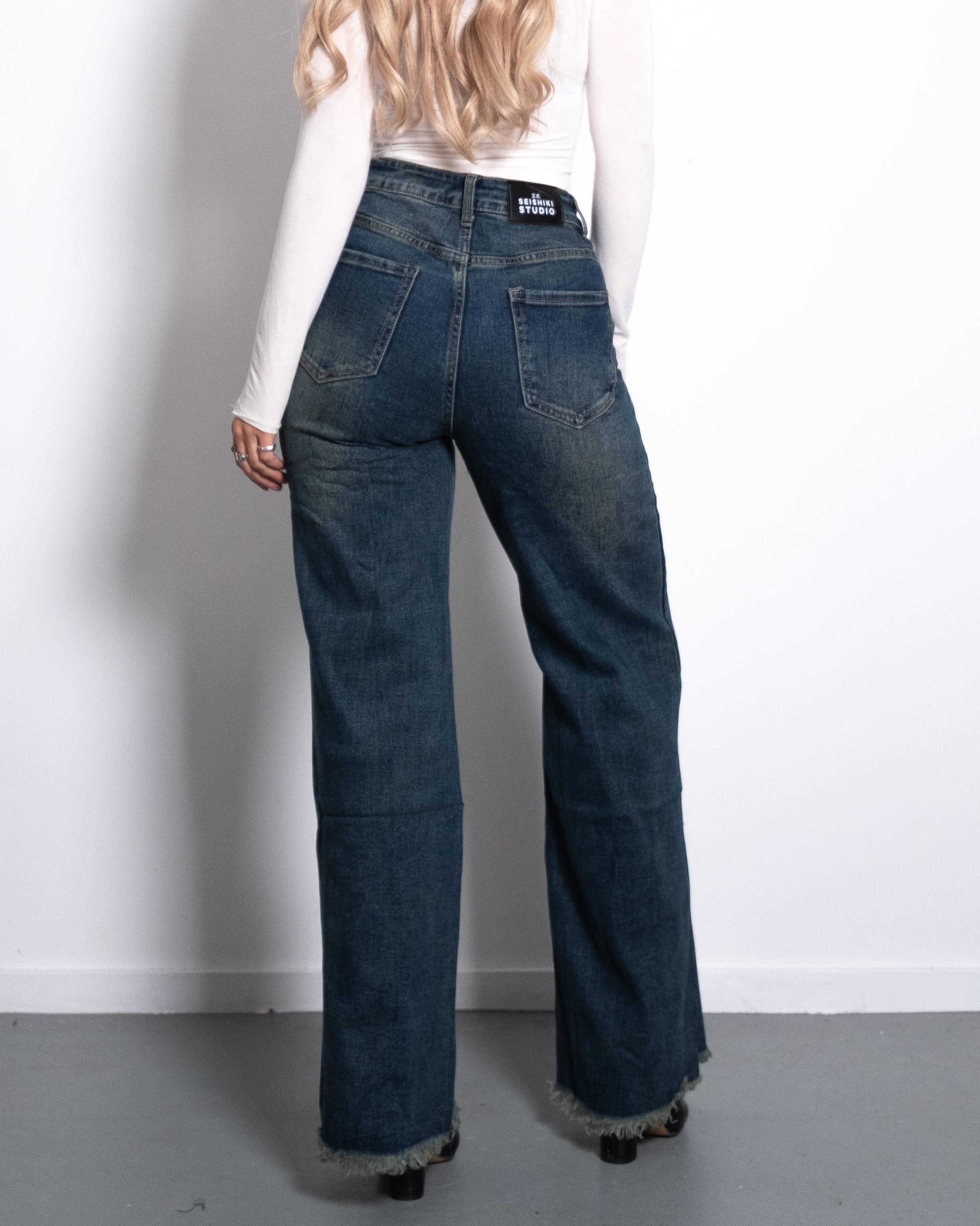 WIDE LEG JEANS WITH FRAYED HEM ACID WASH